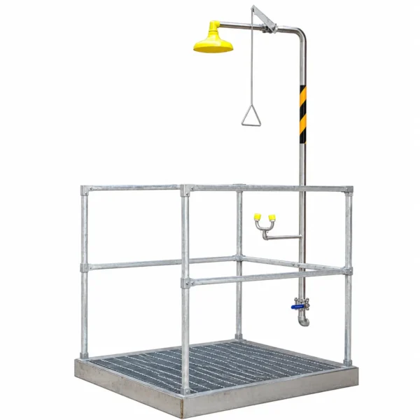 Industrial emergency safety shower and eyewash station with stainless steel frame and grated platform, designed for workplace chemical safety and emergency decontamination.